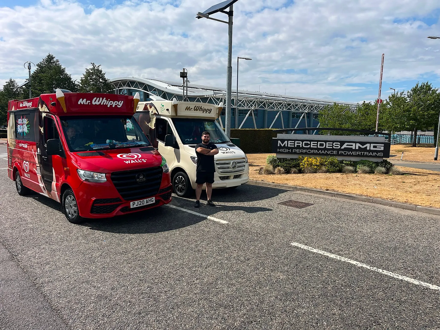 The red and cream Kreamy Delights ice cream vans with a team member at Mercedes-AMG High Performance Powertrains, Brixworth